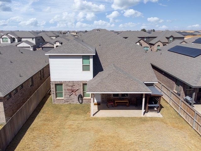 back of house with a residential view, a lawn, and a fenced backyard