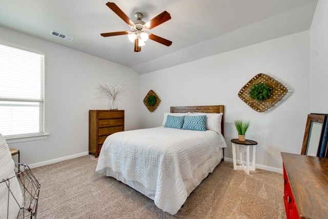 bedroom featuring vaulted ceiling, baseboards, visible vents, and carpet floors