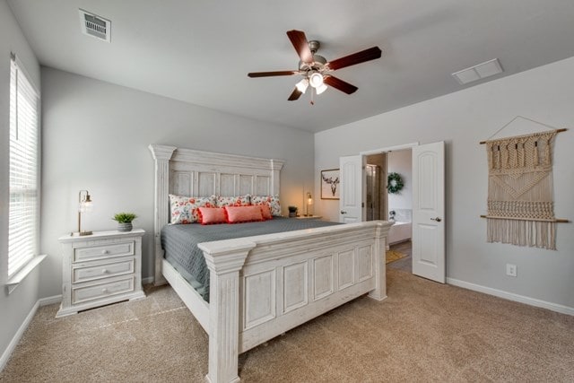 carpeted bedroom featuring visible vents, baseboards, and ceiling fan