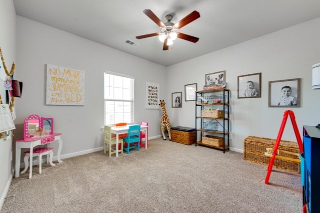 playroom with visible vents, baseboards, ceiling fan, and carpet floors