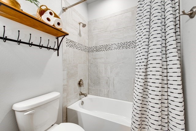 full bathroom with toilet and shower / bathtub combination with curtain