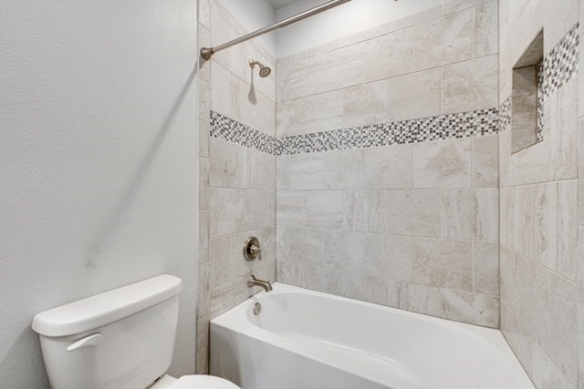 full bathroom with toilet and washtub / shower combination