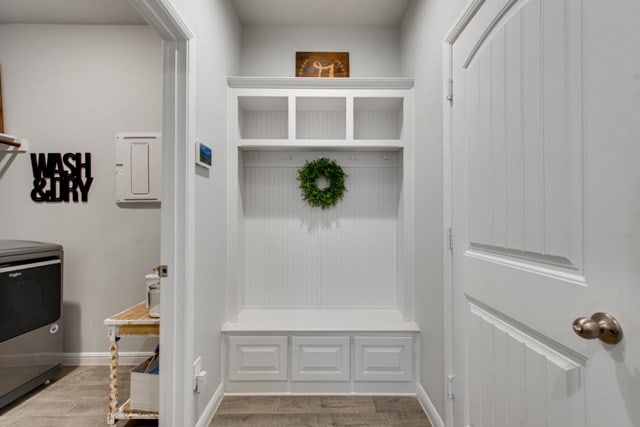 mudroom with light wood finished floors and baseboards