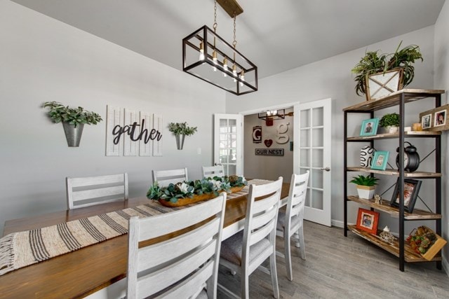 dining room featuring a chandelier and light wood-style flooring