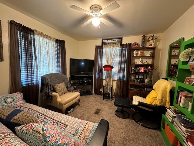 carpeted living room with ceiling fan