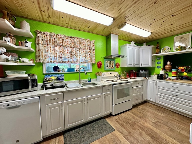 kitchen featuring sink, light hardwood / wood-style floors, white cabinetry, stainless steel appliances, and extractor fan