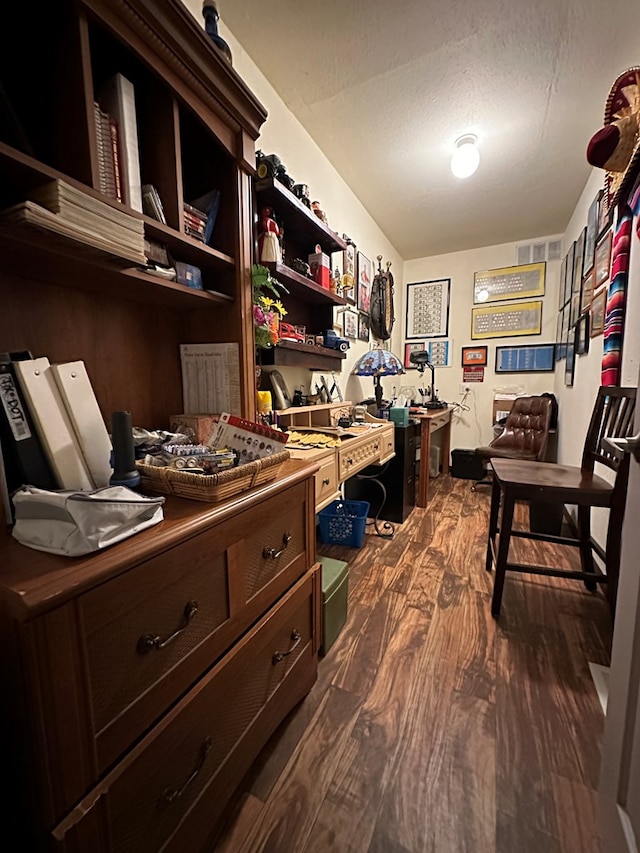 office space featuring a textured ceiling and dark wood-type flooring