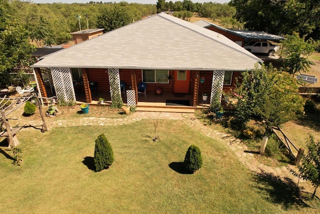 view of front of property with covered porch and a front lawn