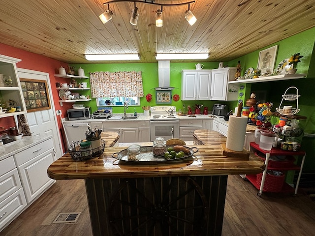 kitchen with island exhaust hood, dark hardwood / wood-style flooring, white range with electric stovetop, a kitchen island, and white cabinetry