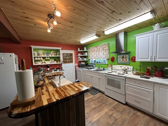 kitchen with white cabinets, white appliances, light hardwood / wood-style flooring, and exhaust hood