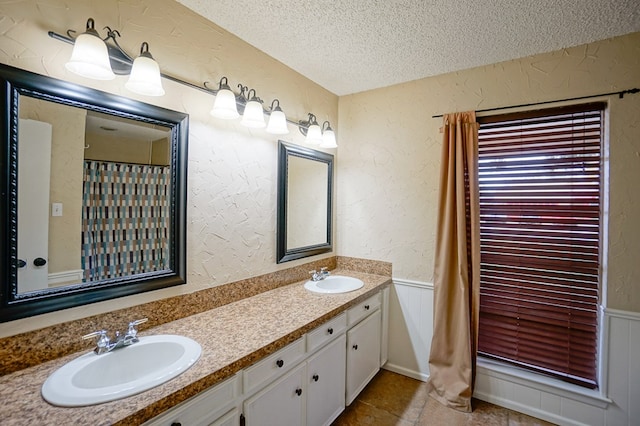 bathroom featuring vanity and a textured ceiling