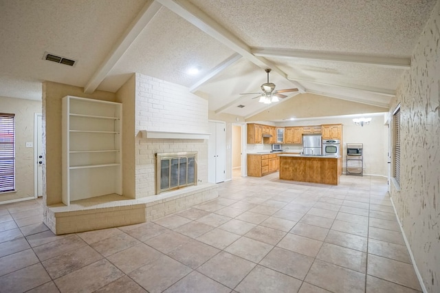 unfurnished living room with ceiling fan, a fireplace, lofted ceiling with beams, and a textured ceiling