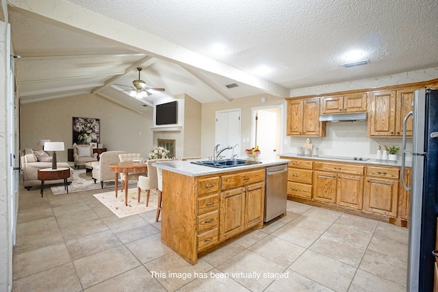 kitchen with sink, ceiling fan, a textured ceiling, a kitchen island, and stainless steel appliances