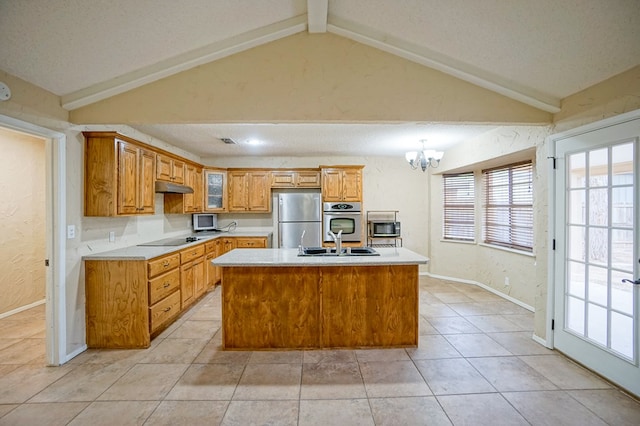 kitchen with a textured ceiling, stainless steel appliances, a kitchen island with sink, an inviting chandelier, and vaulted ceiling with beams