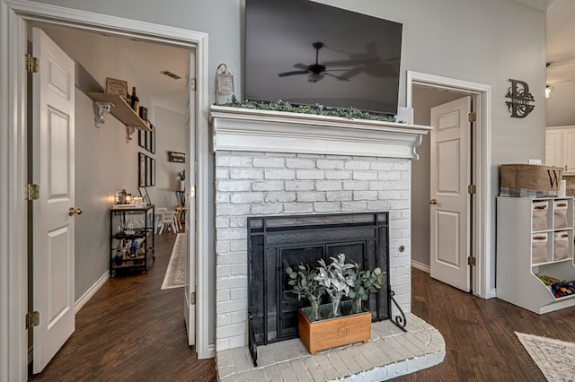 details with visible vents, ceiling fan, wood finished floors, and a fireplace