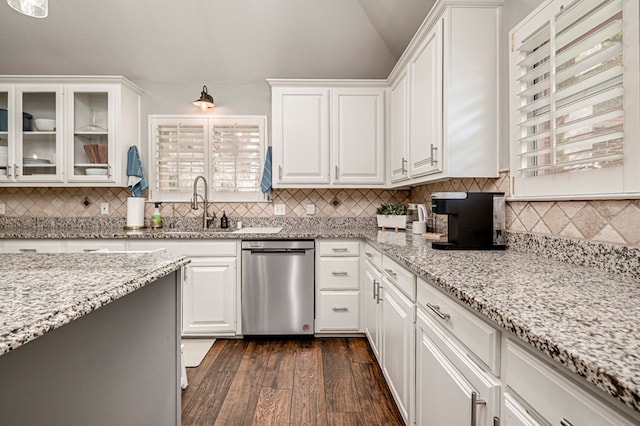 kitchen featuring stainless steel dishwasher, dark wood-style flooring, white cabinetry, and lofted ceiling