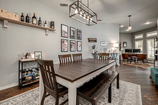 dining room with visible vents, dark wood finished floors, baseboards, an inviting chandelier, and recessed lighting
