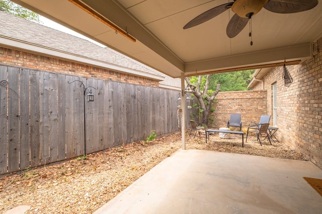 view of patio / terrace with ceiling fan and fence