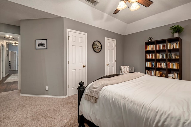 carpeted bedroom with baseboards, visible vents, and ceiling fan