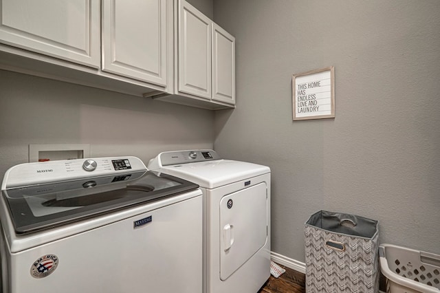 washroom featuring cabinet space, independent washer and dryer, and dark wood-style flooring