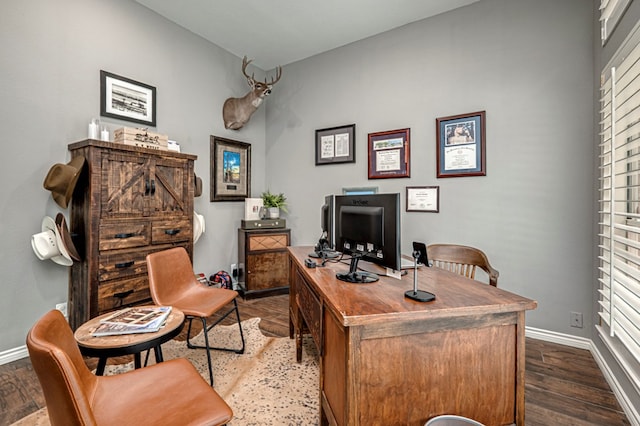 office space with baseboards and dark wood-style floors