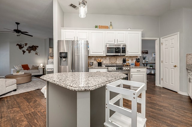 kitchen with ceiling fan, visible vents, appliances with stainless steel finishes, tasteful backsplash, and dark wood-style floors