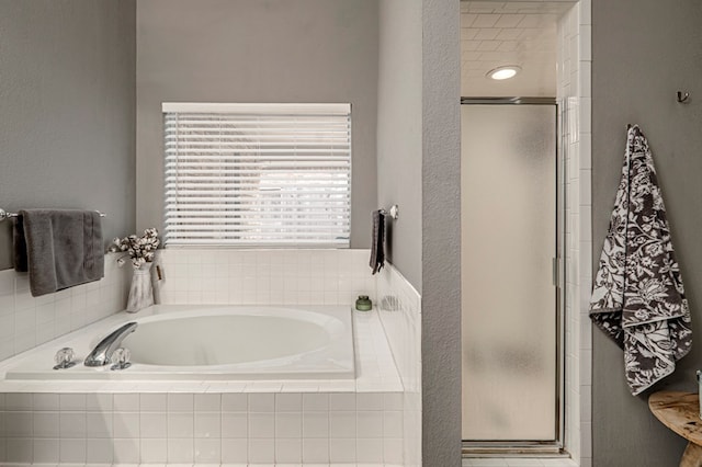 full bathroom with a garden tub and a shower stall