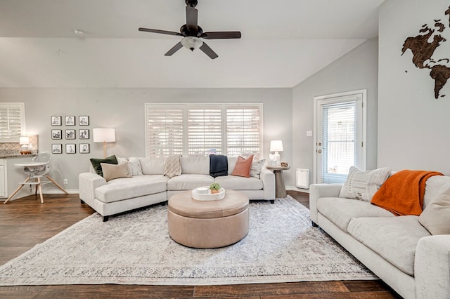 living room featuring baseboards, a ceiling fan, dark wood-style flooring, and lofted ceiling