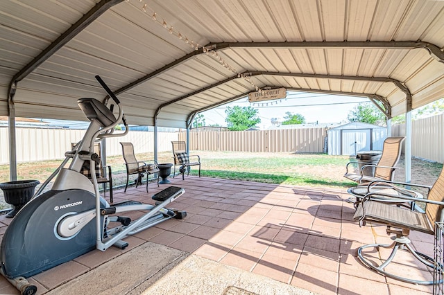 view of patio / terrace featuring an outbuilding, a storage shed, and a fenced backyard