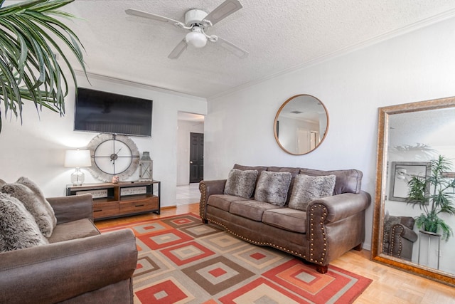 living area featuring ornamental molding, a ceiling fan, and a textured ceiling