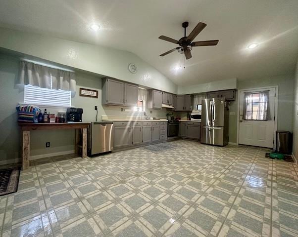 kitchen featuring lofted ceiling, refrigerator, ceiling fan, stainless steel fridge, and gray cabinets