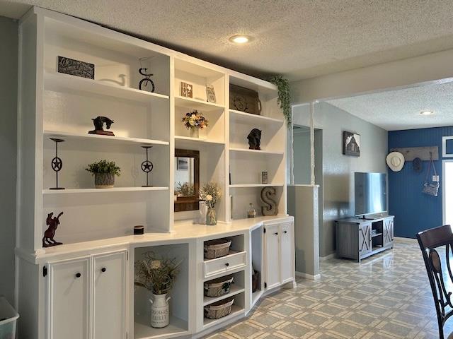 interior space with white cabinetry and a textured ceiling