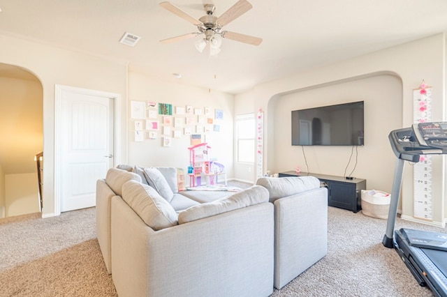 carpeted living room with ceiling fan