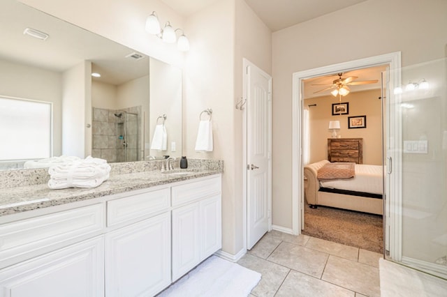 bathroom featuring tile patterned floors, vanity, ceiling fan, and walk in shower