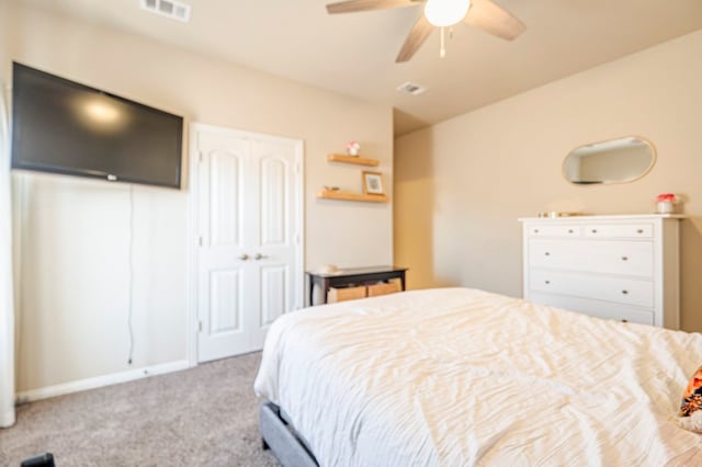 carpeted bedroom featuring ceiling fan and a closet