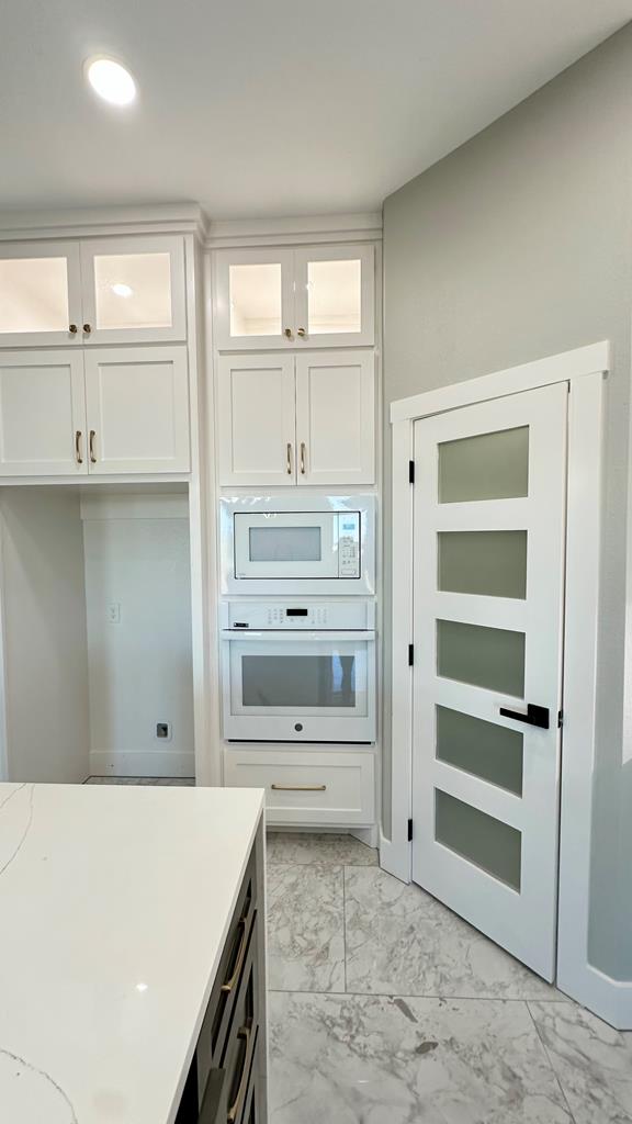 laundry area featuring washer hookup, cabinets, sink, and hookup for an electric dryer