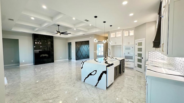 kitchen with coffered ceiling, sink, pendant lighting, white appliances, and white cabinets