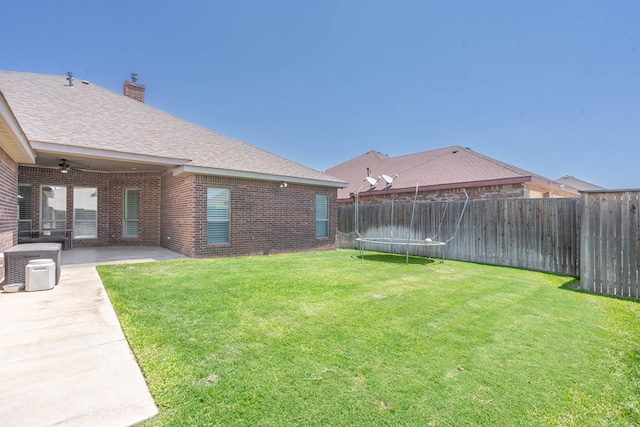 7604 Keyhaven, Odessa, TX 79765 - fenced backyard with a trampoline, ceiling fan, and a patio area
