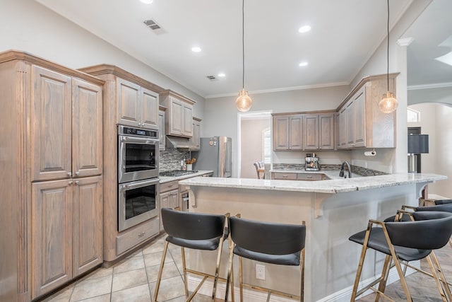 7604 Keyhaven, Odessa, TX 79765 - kitchen featuring appliances with stainless steel finishes, a peninsula, a kitchen breakfast bar, recessed lighting, and light stone counters
