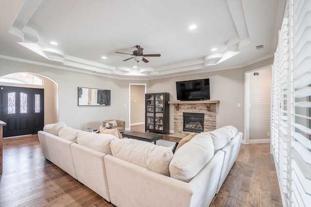 7604 Keyhaven, Odessa, TX 79765 - living room with a tray ceiling, a ceiling fan, crown molding, a fireplace, and recessed lighting