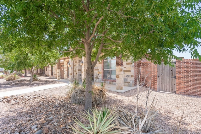 7604 Keyhaven, Odessa, TX 79765 - view of property hidden behind natural elements with brick siding