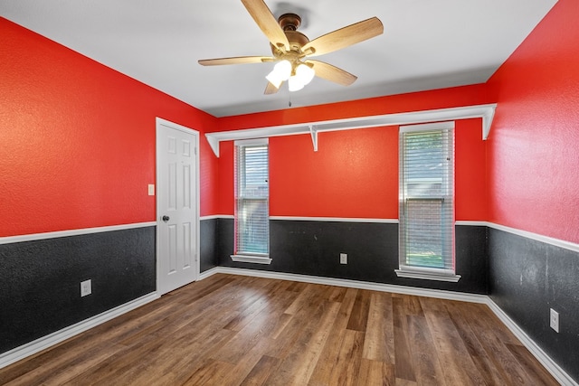 empty room featuring hardwood / wood-style floors and ceiling fan