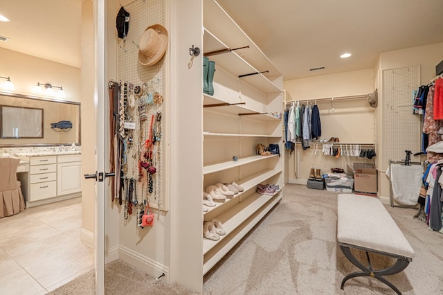 spacious closet featuring light carpet