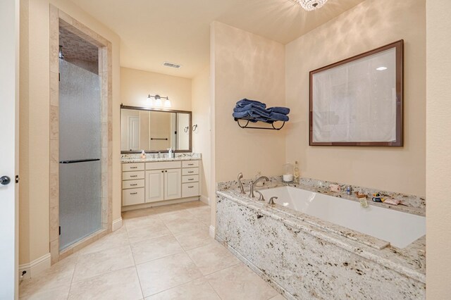 walk in closet with light carpet, visible vents, light tile patterned flooring, and built in study area