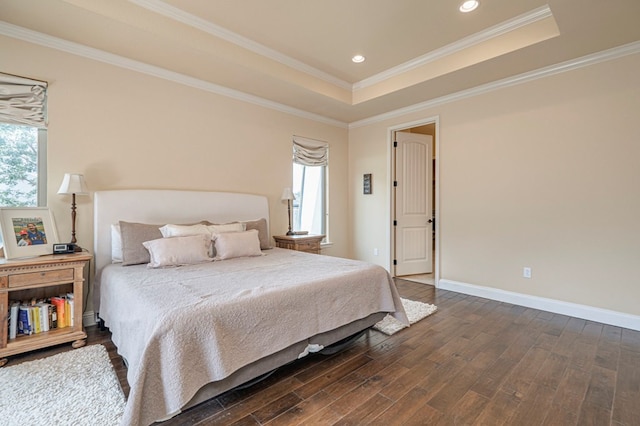 bedroom featuring dark hardwood / wood-style floors, a raised ceiling, and ornamental molding