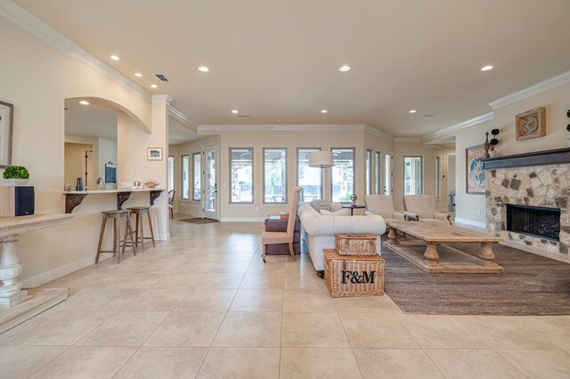 kitchen featuring light tile patterned floors, baseboards, appliances with stainless steel finishes, light stone countertops, and glass insert cabinets