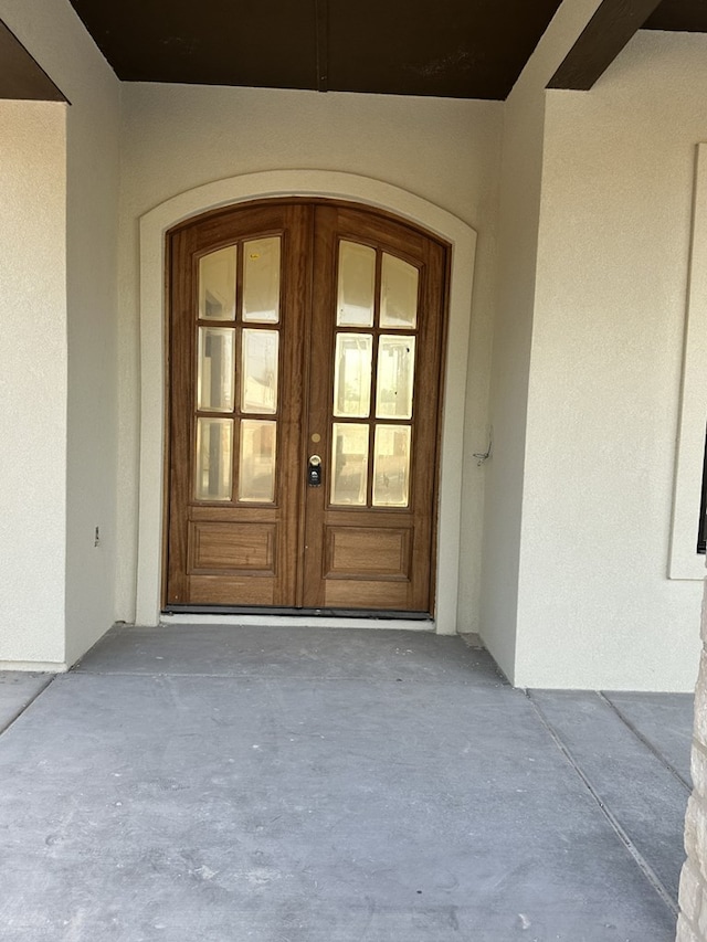 doorway to property with french doors and stucco siding