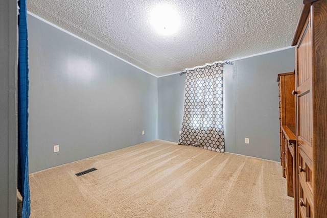 50031 E County Rd 71, Midland, TX 79705 - empty room with crown molding, a textured ceiling, and carpet flooring