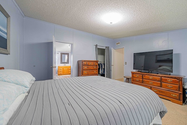 50031 E County Rd 71, Midland, TX 79705 - bedroom featuring a textured ceiling, carpet floors, ensuite bathroom, and a sink