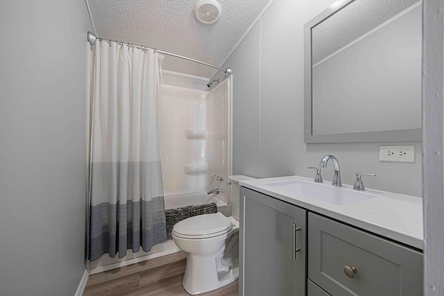 50031 E County Rd 71, Midland, TX 79705 - full bathroom featuring a textured ceiling, wood finished floors, vanity, shower / bath combination with curtain, and toilet